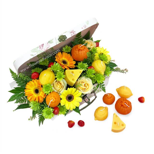 Bright yellow and orange flower arrangement in gift box for flower delivery