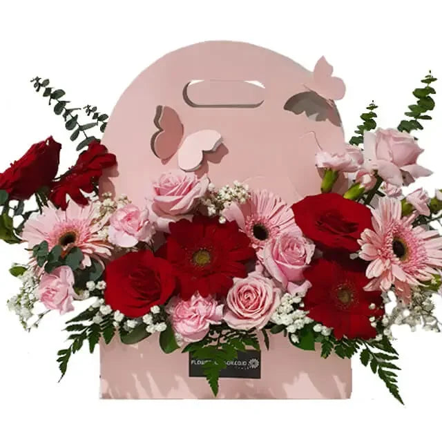 Hand-carry pink and red floral arrangement in a gift box for flower delivery