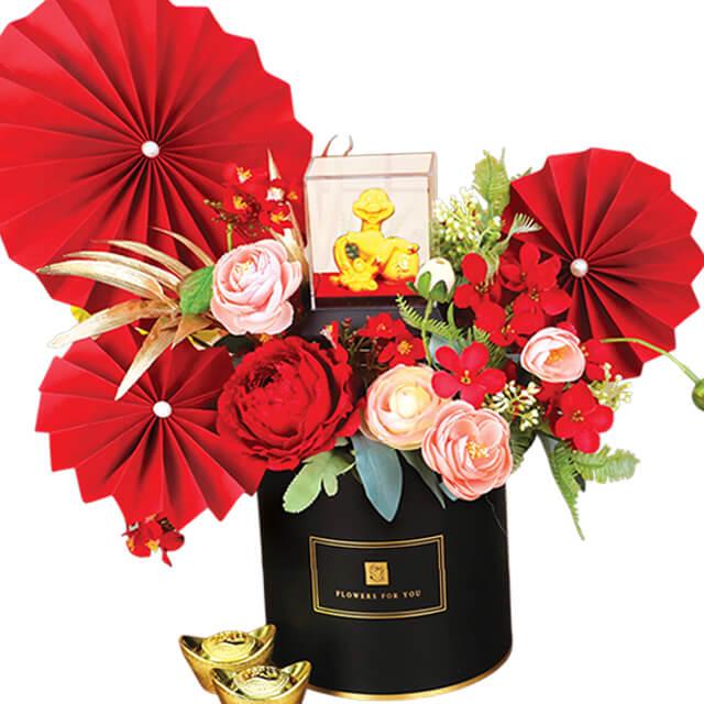 Peony and rose floral arrangement with red paper fans and gold ornaments for flower delivery