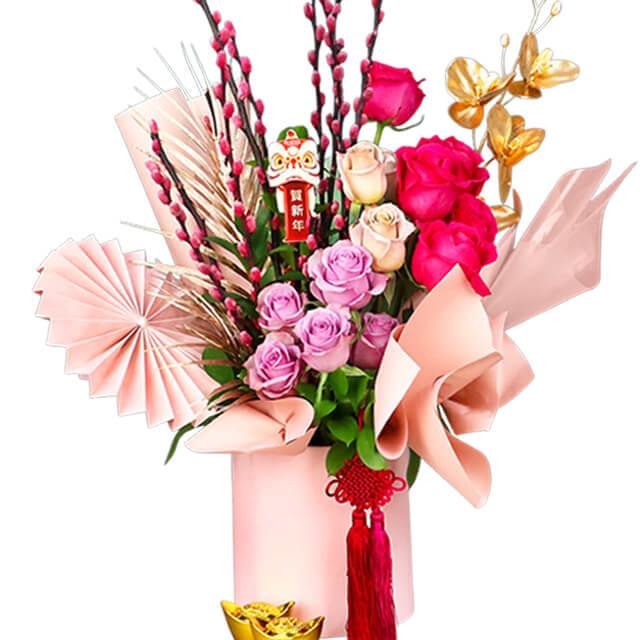Festive flower bouquet with pink and red roses, gold accents, ideal for flower delivery