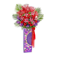 Grand opening flower stand with red gerberas, lilies, and palm leaves for delivery