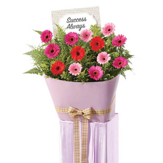 Congratulatory flower stand with pink and red gerberas for flower delivery in Singapore
