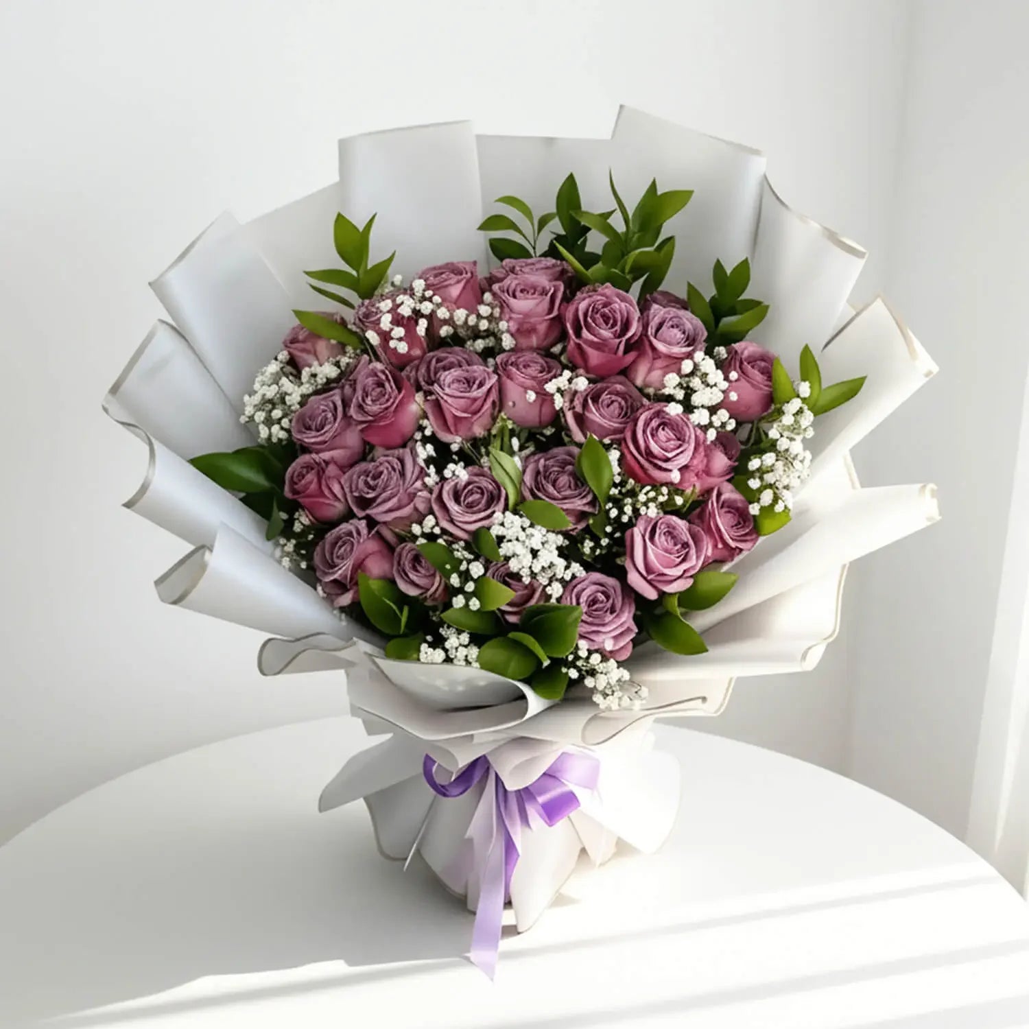 Elegant bouquet of purple roses and baby's breath with greenery, perfect for flower delivery