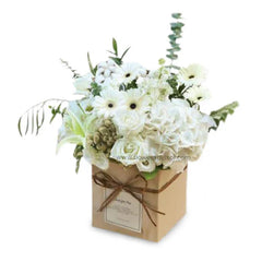 Elegant white flower arrangement in a kraft box for flower delivery