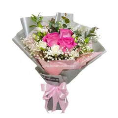 Pink rose bouquet with white baby’s breath, greenery, and pink ribbon for flower delivery