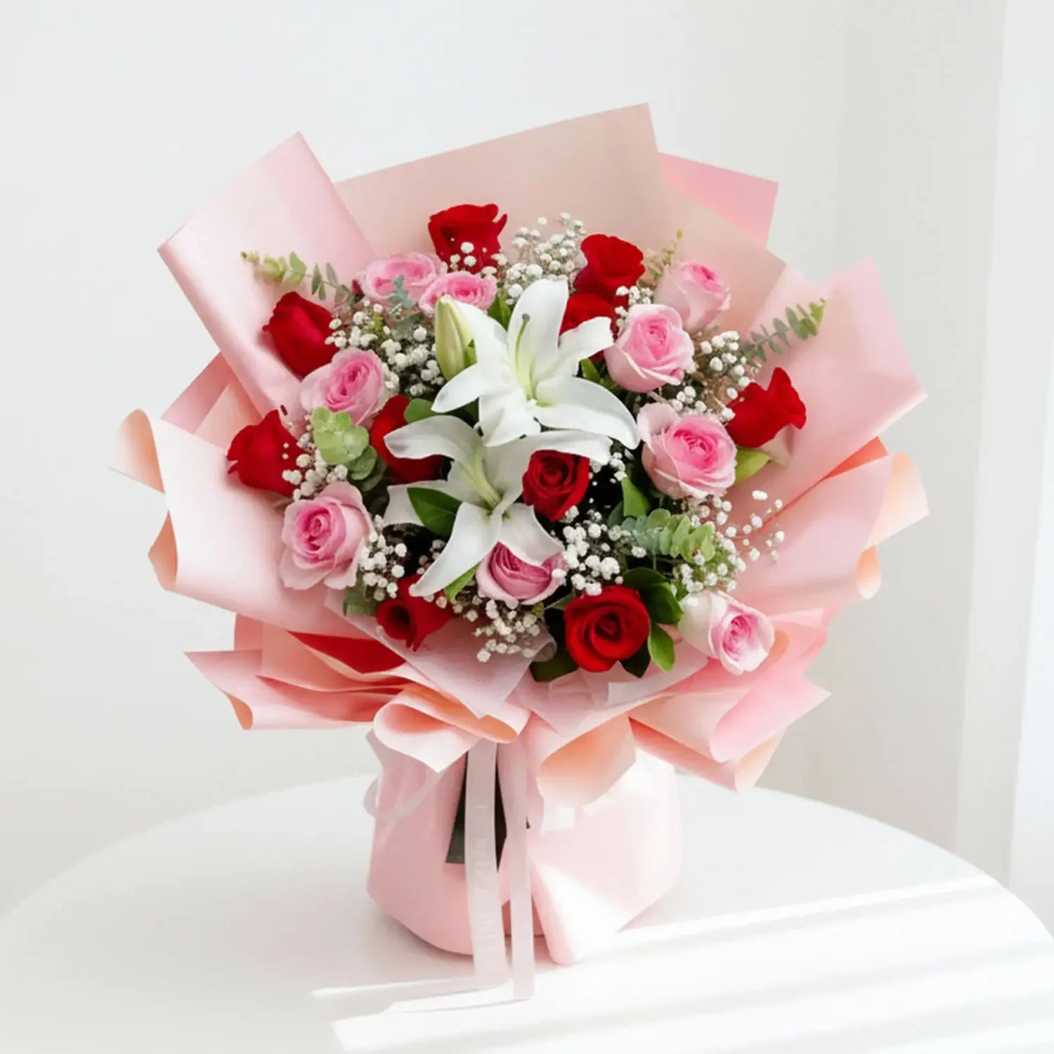 Elegant pink and red rose bouquet with lilies, perfect for flower delivery in Singapore.