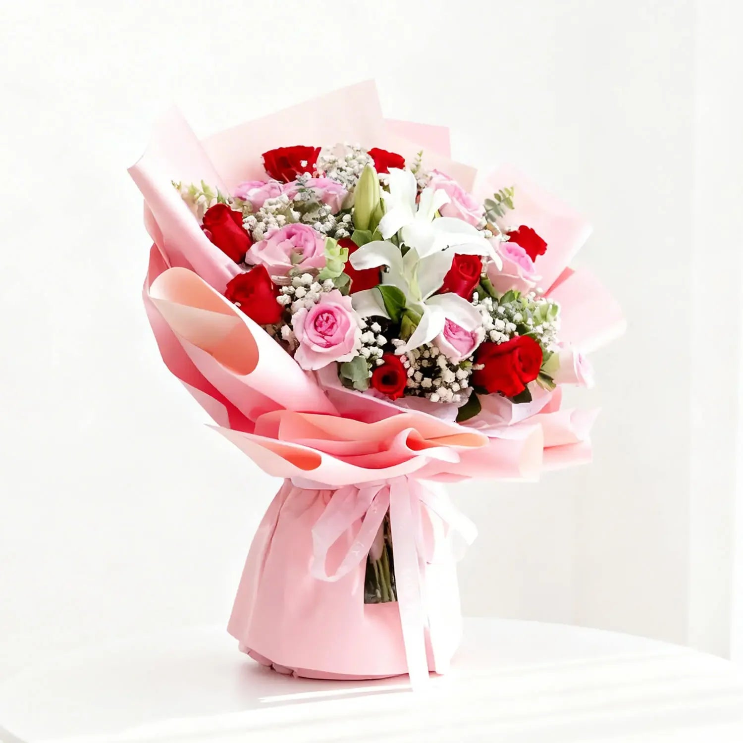 Elegant flower bouquet with red roses, pink roses, lilies and baby's breath for delivery