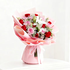 Elegant flower bouquet with red roses, pink roses, lilies and baby's breath for delivery