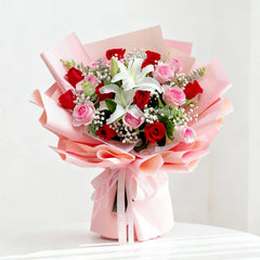 Beautiful flower delivery bouquet with red roses, pink roses, lilies, and baby's breath