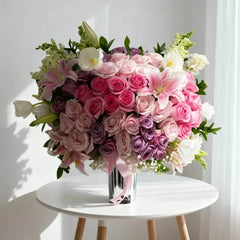 Elegant pink and purple rose bouquet with lilies in vase, perfect for flower delivery