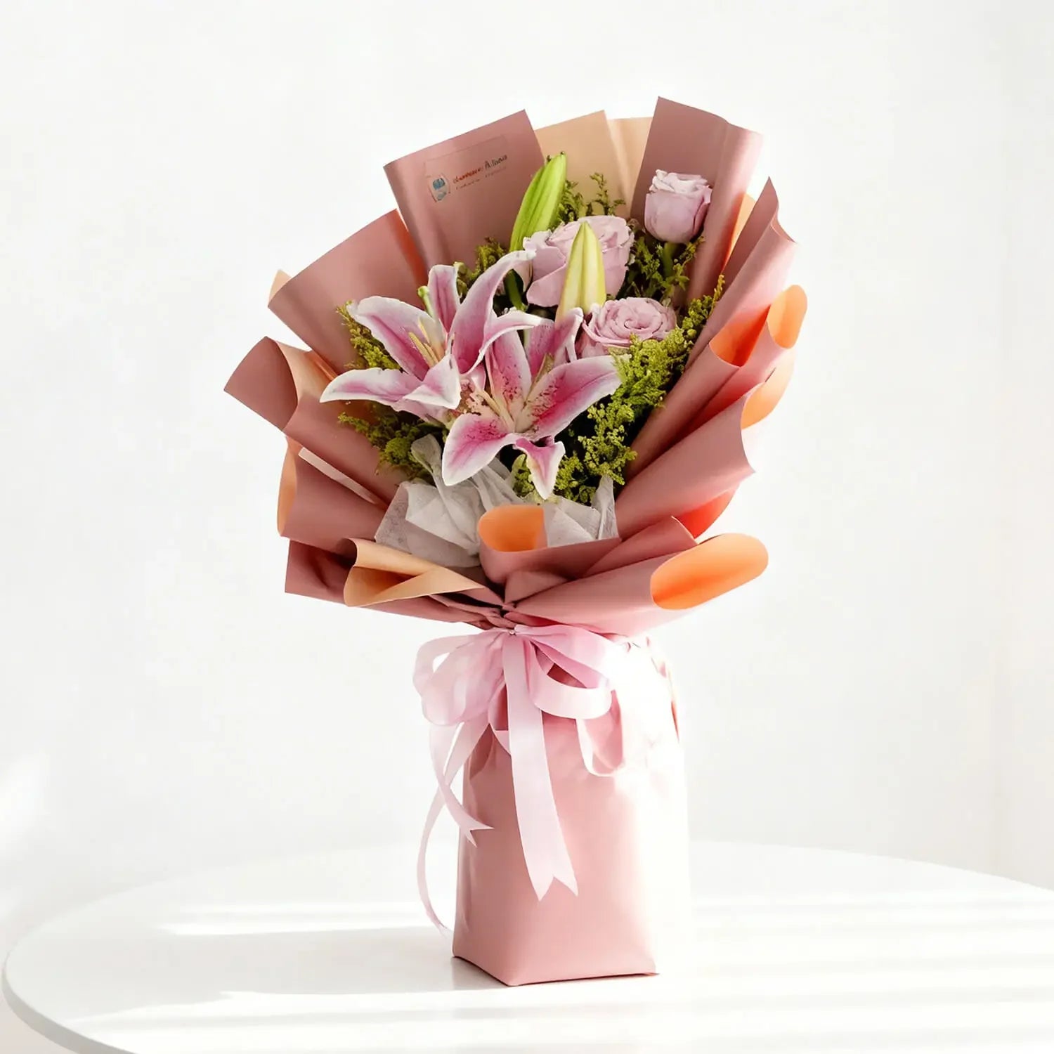 Elegant pink lily and rose bouquet in gift wrap for flower delivery in Singapore