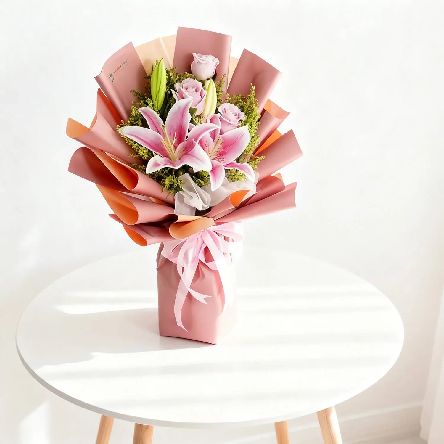 Elegant pink lily and rose bouquet for flower delivery, wrapped in pastel paper on table