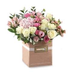 Elegant flower delivery box with pink and white roses, hydrangeas and greenery