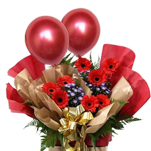 Festive flower arrangement with red gerberas, purple accents, gold ribbon and balloons for delivery