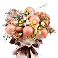 Elegant flower bouquet with roses, eustoma and decorative metallic balloons for delivery