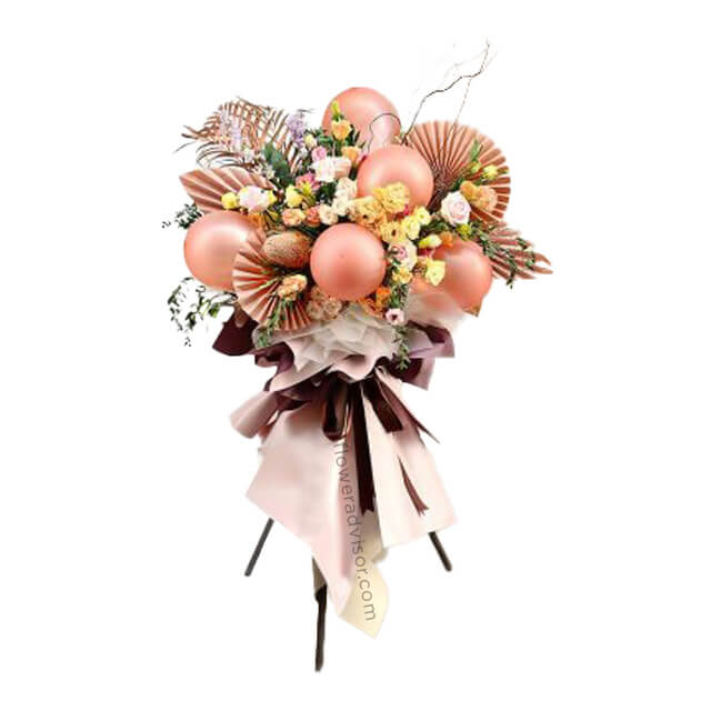Elegant flower arrangement for delivery with roses, eustoma, and metallic balloons.