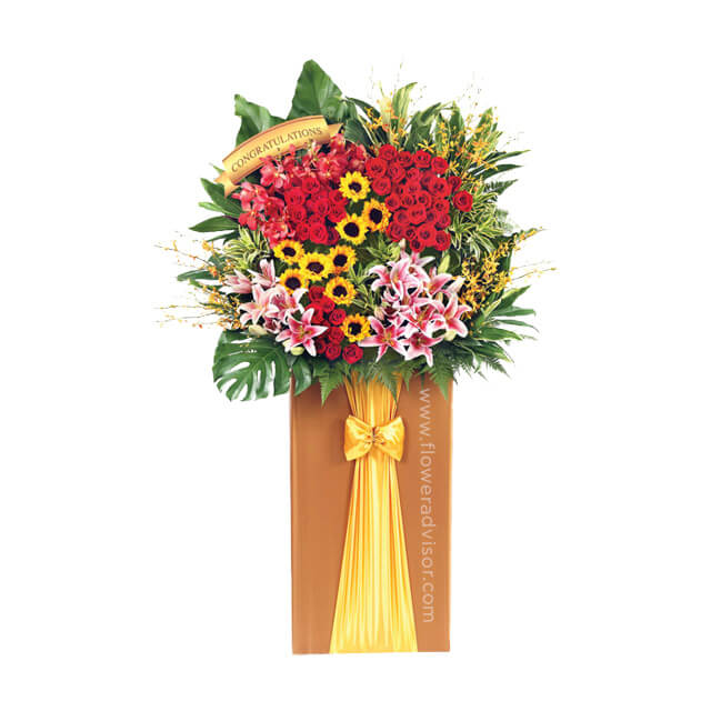 Grand congratulatory flower stand with roses, lilies, sunflowers and greenery for delivery