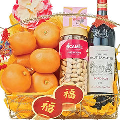 Chinese New Year gift hamper with fresh oranges, pistachios, wine, and festive flowers for delivery