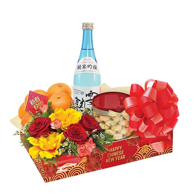 Chinese New Year flower hamper with fresh bouquet, oranges, and festive treats for delivery