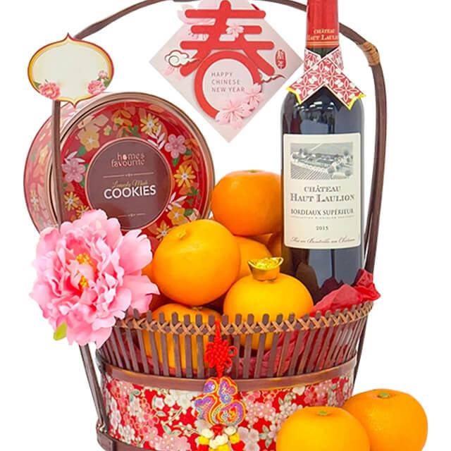 Chinese New Year flower delivery hamper with oranges, wine, cookies and pink flower