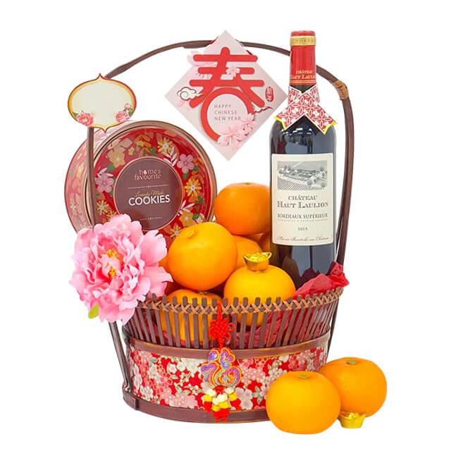 Chinese New Year flower delivery hamper with oranges, wine, cookies and festive flowers