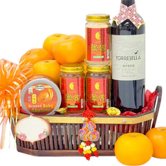 Chinese New Year fruit and hamper basket with oranges, wine, and festive flowers for delivery