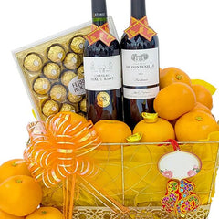 Chinese New Year hamper with oranges, wine, chocolates, and festive ribbon for delivery