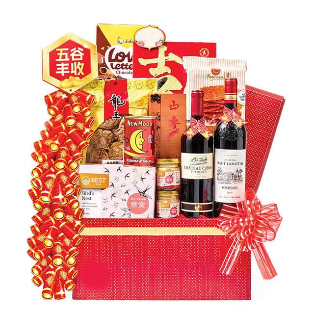 Chinese New Year festive hamper with wine, snacks, bird's nest and decorative ribbons for delivery