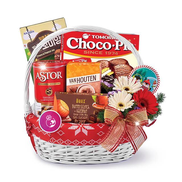Festive gift basket with fresh flowers, chocolate treats, ideal for flower delivery in Singapore