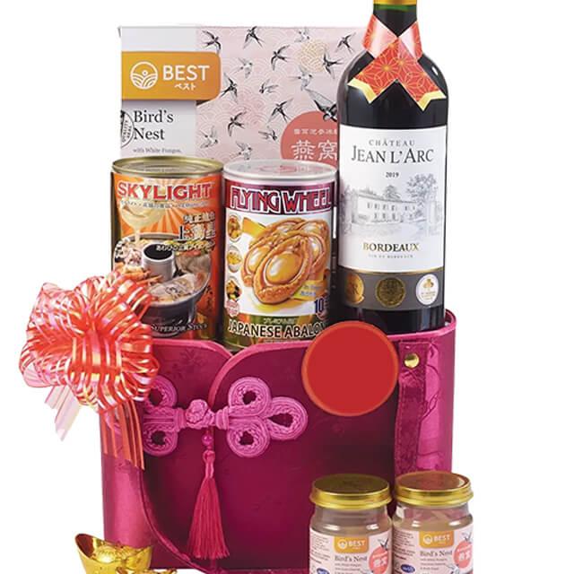 Luxurious gourmet hamper with wine, abalone, bird's nest and festive gift packaging for flower delivery
