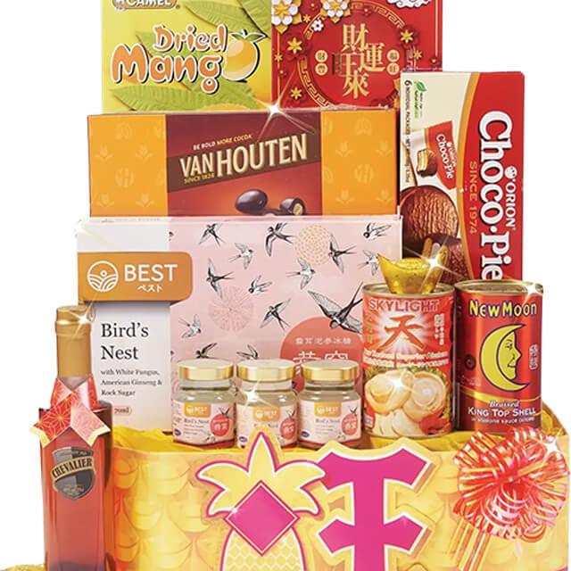 Festive hamper with dried mango, assorted snacks, and flower accents for gift delivery