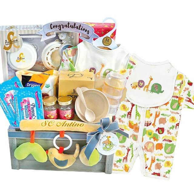 Baby gift hamper with animal print clothes, toys, feeding set, and assorted essentials, ideal for flower delivery gifts.