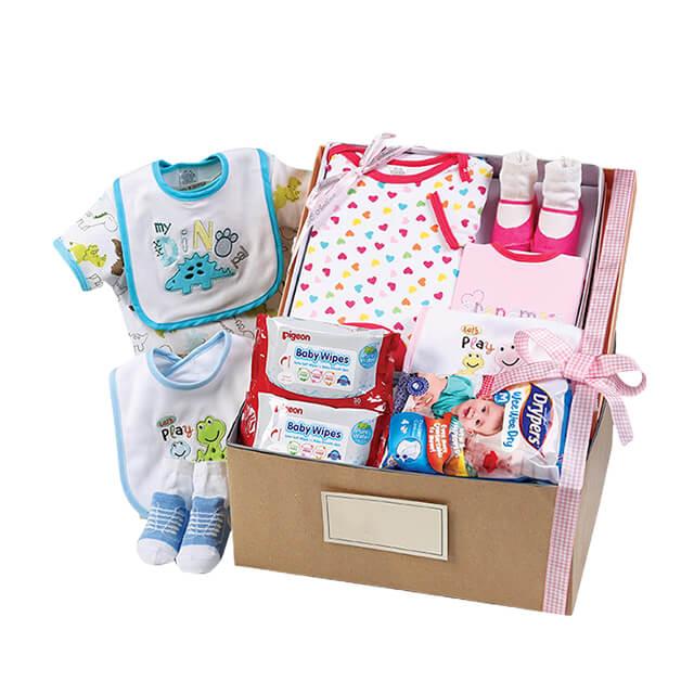 Baby gift hamper with baby clothes, wipes, socks, bibs and essentials for flower delivery