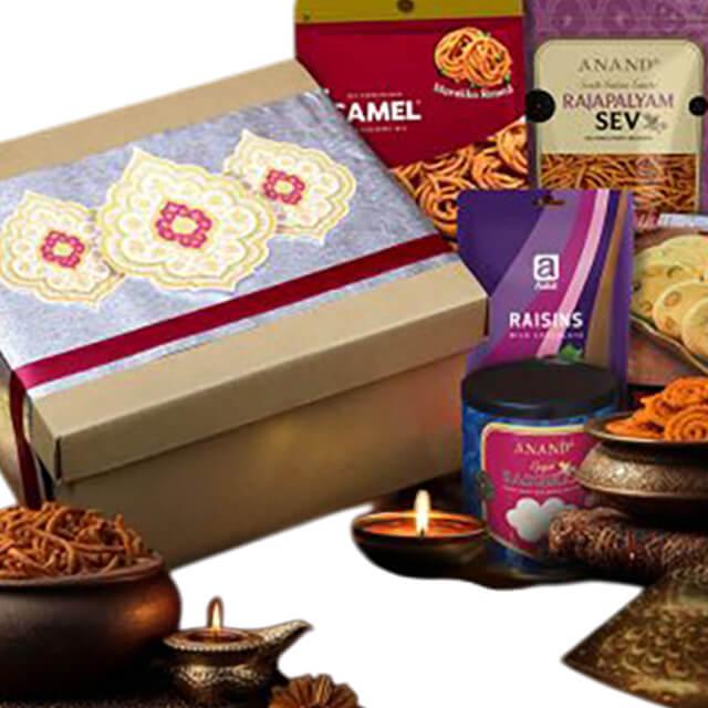Elegant festive hamper with snacks, sweets and gift box, ideal for flower delivery gifting.