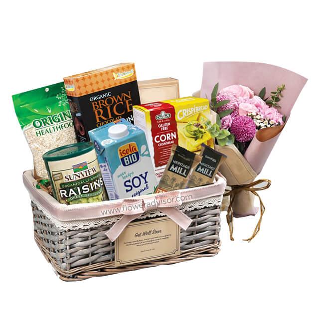 Flower delivery hamper with fresh bouquet, healthy snacks, and gourmet gift basket