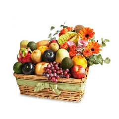 Fresh fruit hamper with vibrant orange flowers for flower delivery Singapore