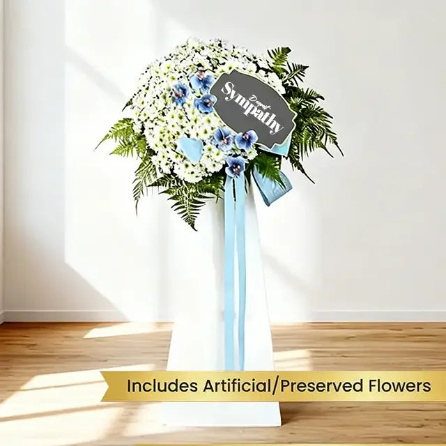 Sympathy floral stand with white and blue preserved flowers, ideal for flower delivery