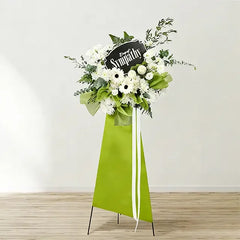 Sympathy funeral flower stand with white blooms and greenery for flower delivery