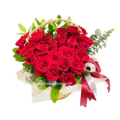 Red rose basket arrangement with greenery, perfect for flower delivery in Singapore