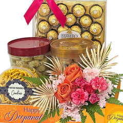 Deepavali flower delivery set with roses, pink carnations, chocolates, and festive snacks