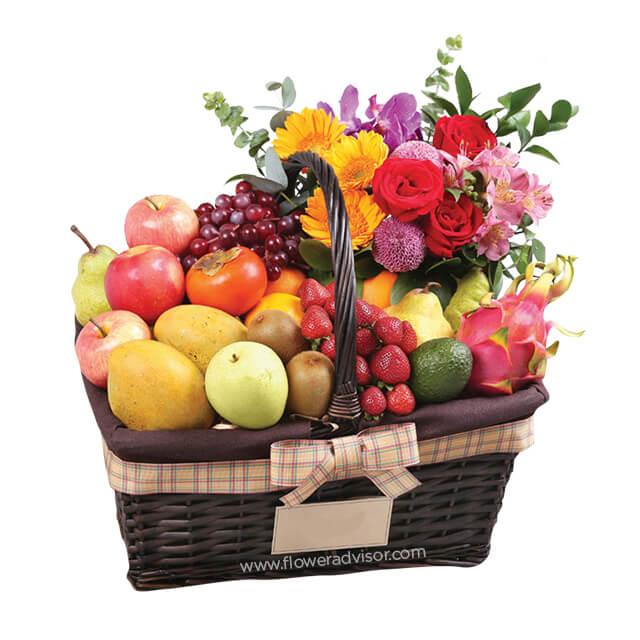 Fruit and flower hamper basket with fresh blooms for online flower delivery