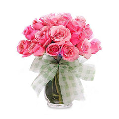 Two dozen pink roses in a vase with a ribbon, perfect for flower delivery in Singapore