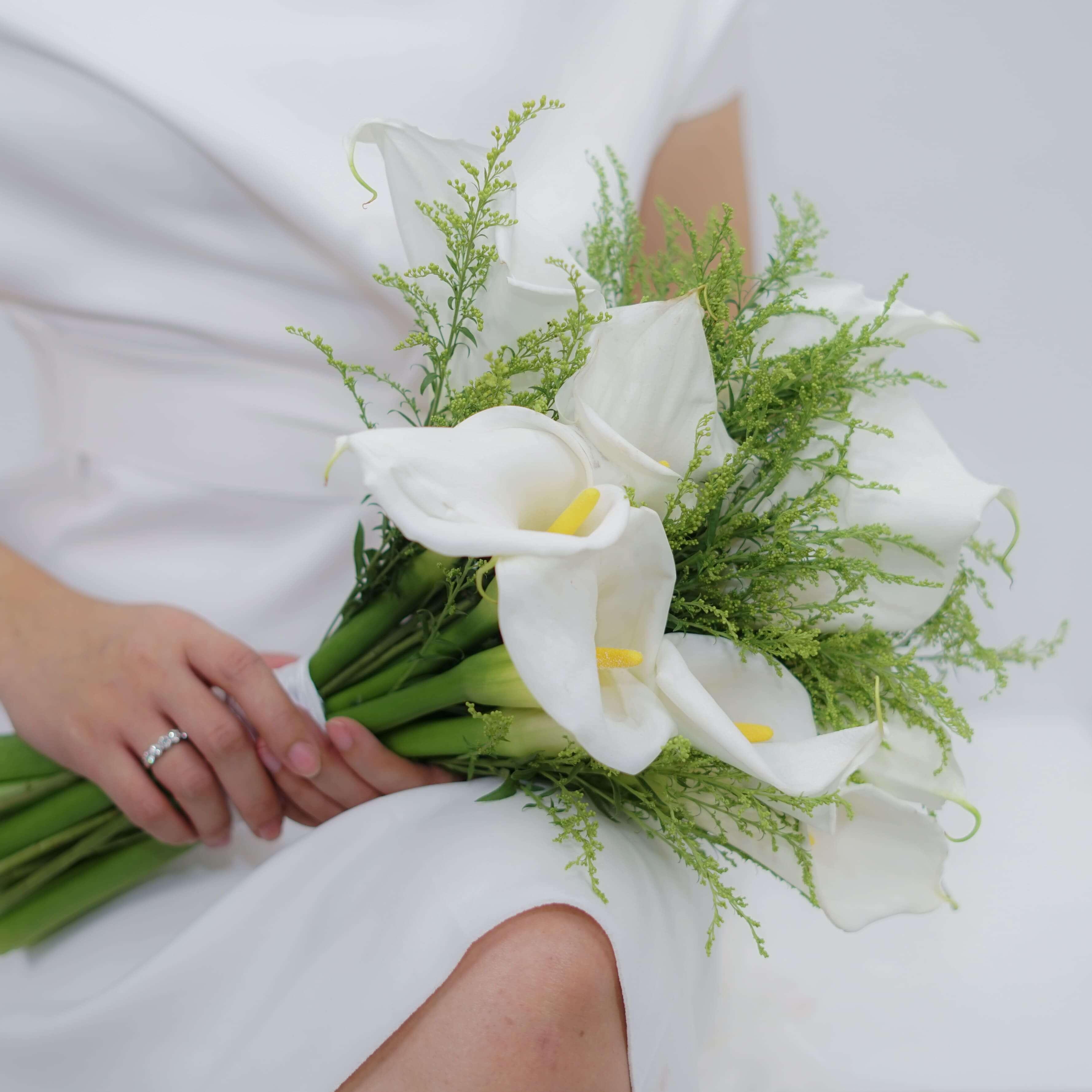 White calla lilies bouquet with greenery, ideal for elegant flower delivery