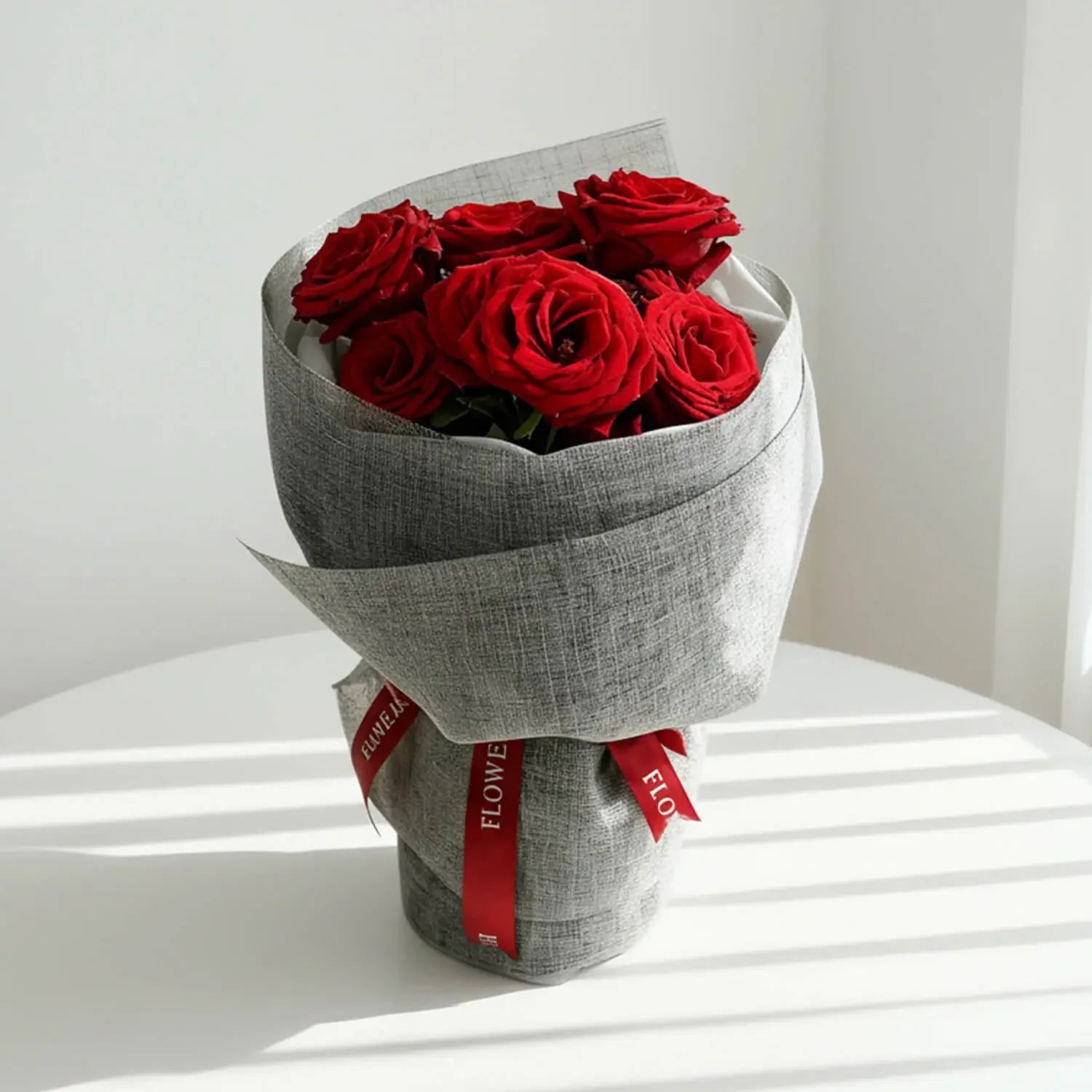 Elegant bouquet of fresh red roses in grey wrapping, ideal for flower delivery in Singapore