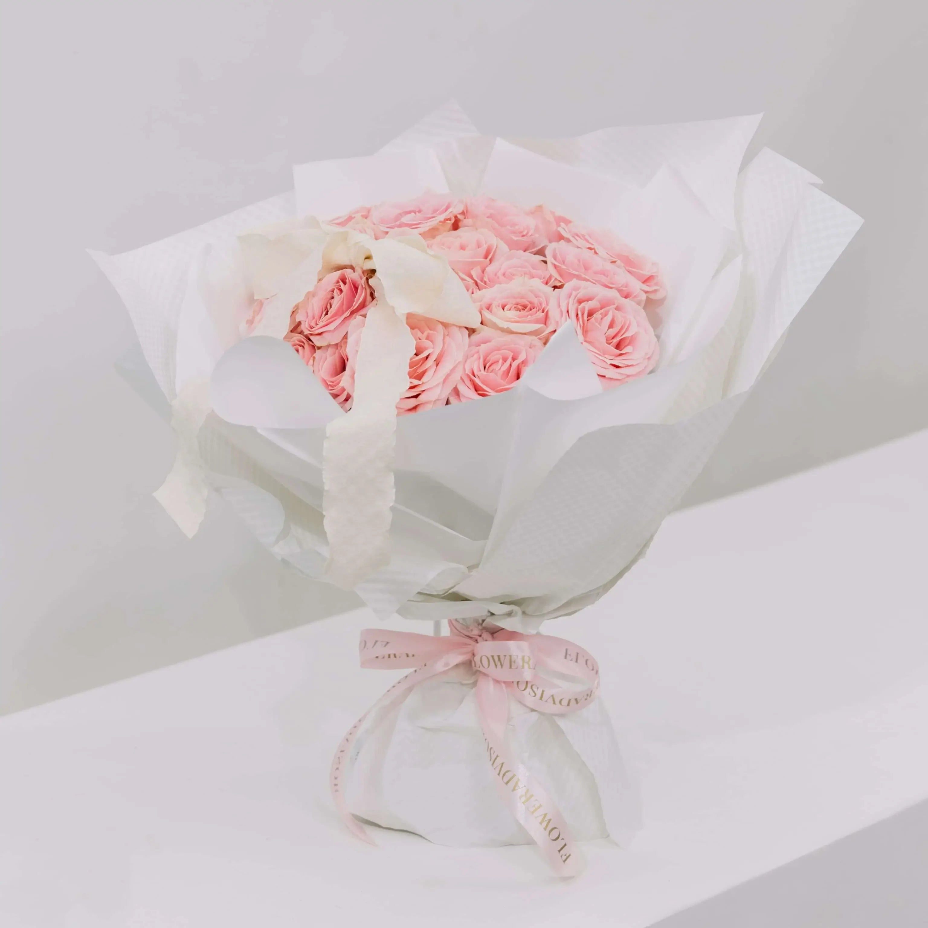 Elegant bouquet of pink roses with white wrapping, perfect for flower delivery gift