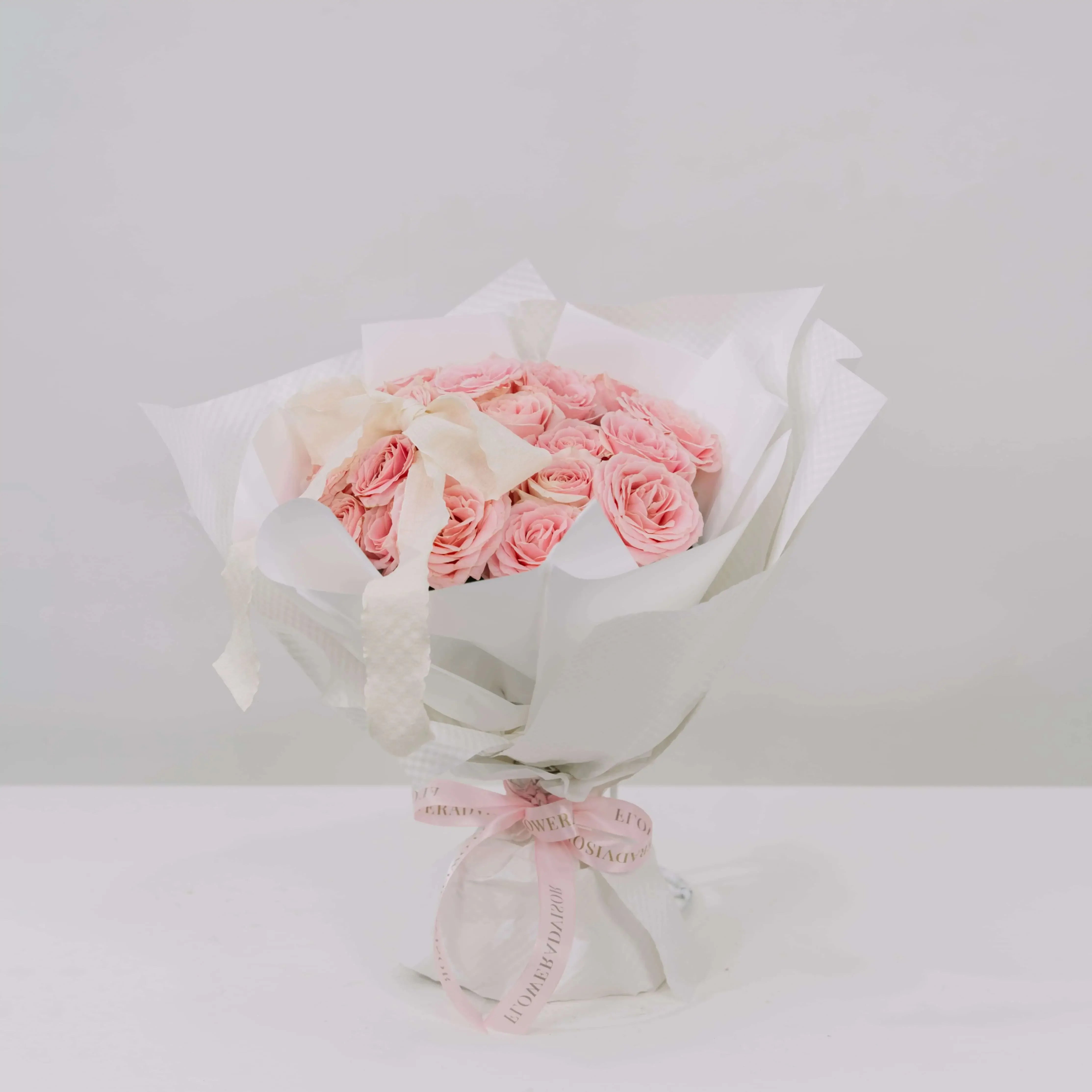 Elegant bouquet of pink roses with white wrapping, perfect for flower delivery in Singapore
