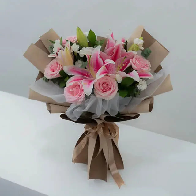 Pink lilies and roses bouquet with greenery, perfect for same-day flower delivery.