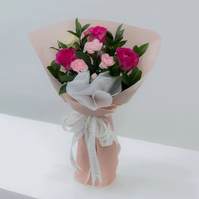 Pink and white rose bouquet with same-day flower delivery, wrapped in pink paper and ribbon