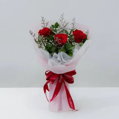 Fresh red rose bouquet with greenery and white accents, ideal for flower delivery in Singapore