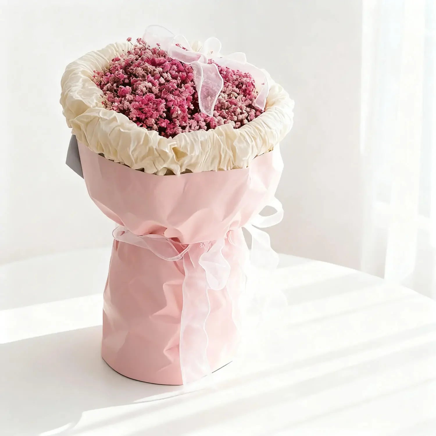 Pink baby's breath bouquet in pastel wrapping with ribbon, perfect for flower delivery Singapore